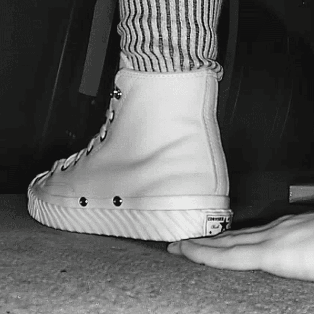 Woman in high-top Converse unaware hand trample + sneaker unaware hand trample 1