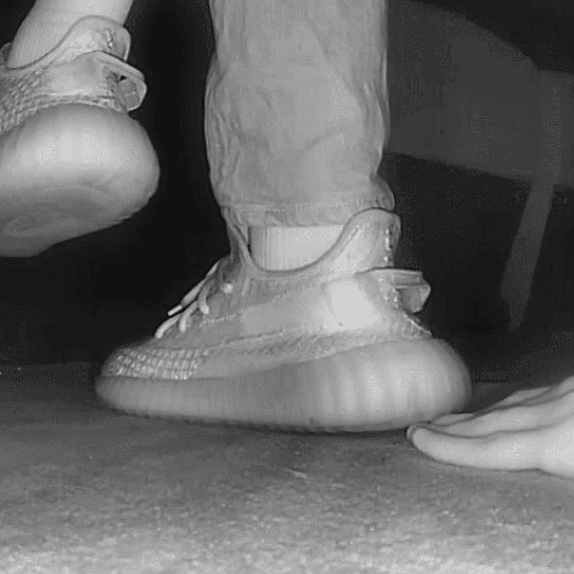 Woman in adidas yeezy sneaker unaware hand trample in cinema