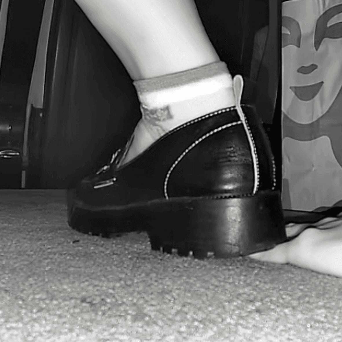 Woman in cinema unaware hand trample with leather shoes