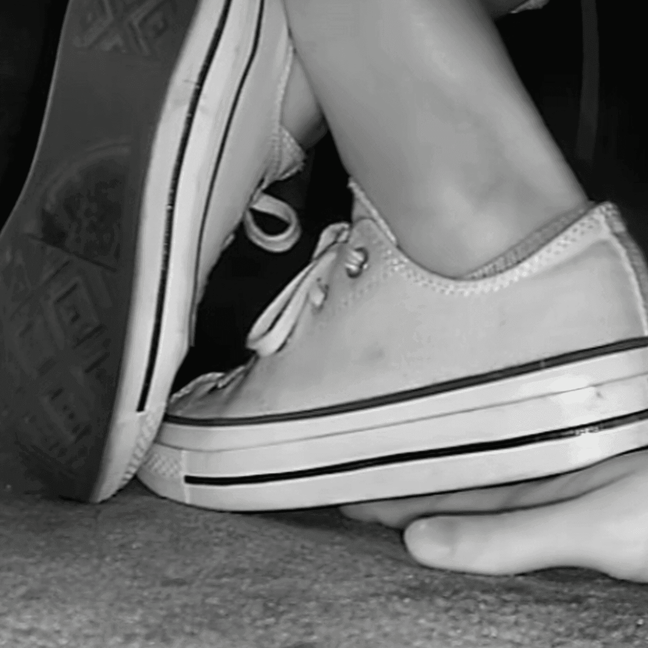 Woman in cinema wearing flat shoes + low-top Converse shoes unaware hand trample