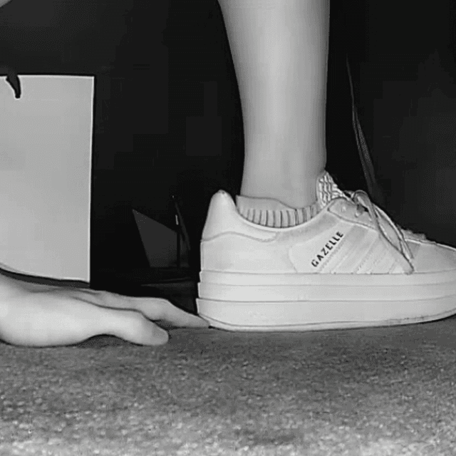Woman unaware hand trample with sneakers and ankle boots in cinema 2