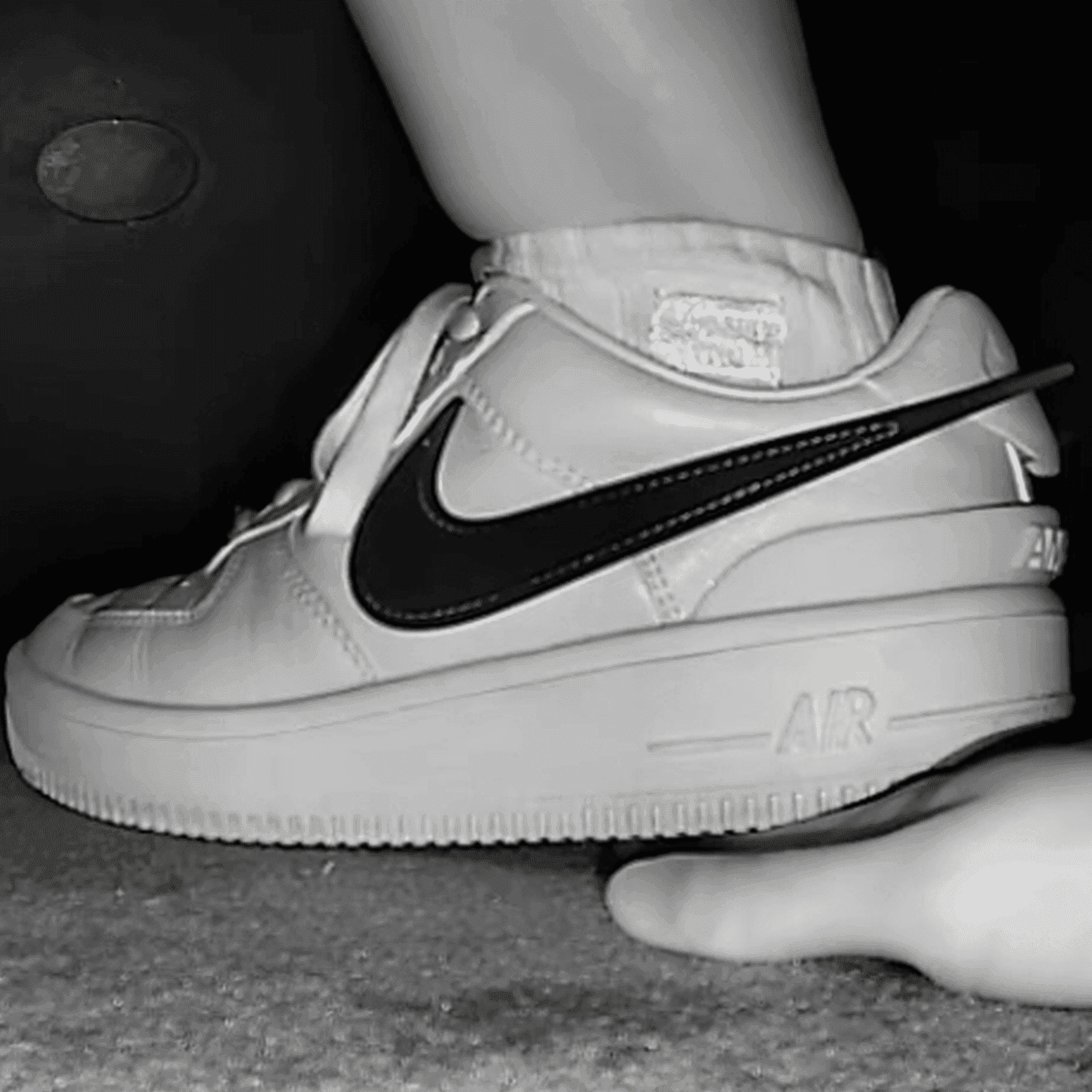 Woman in cinema unaware hand trample with Nike Air Force 1 sneakers