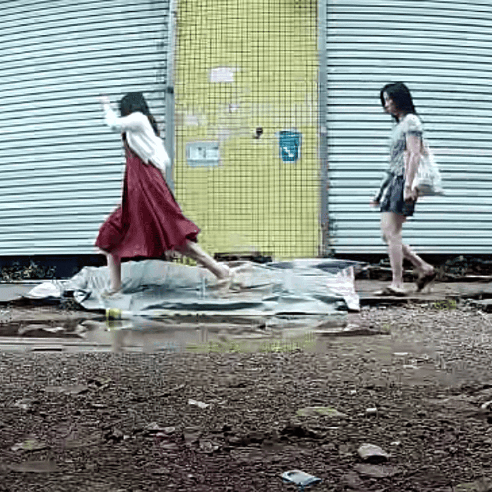 Outdoor human carpet unaware trampled by women