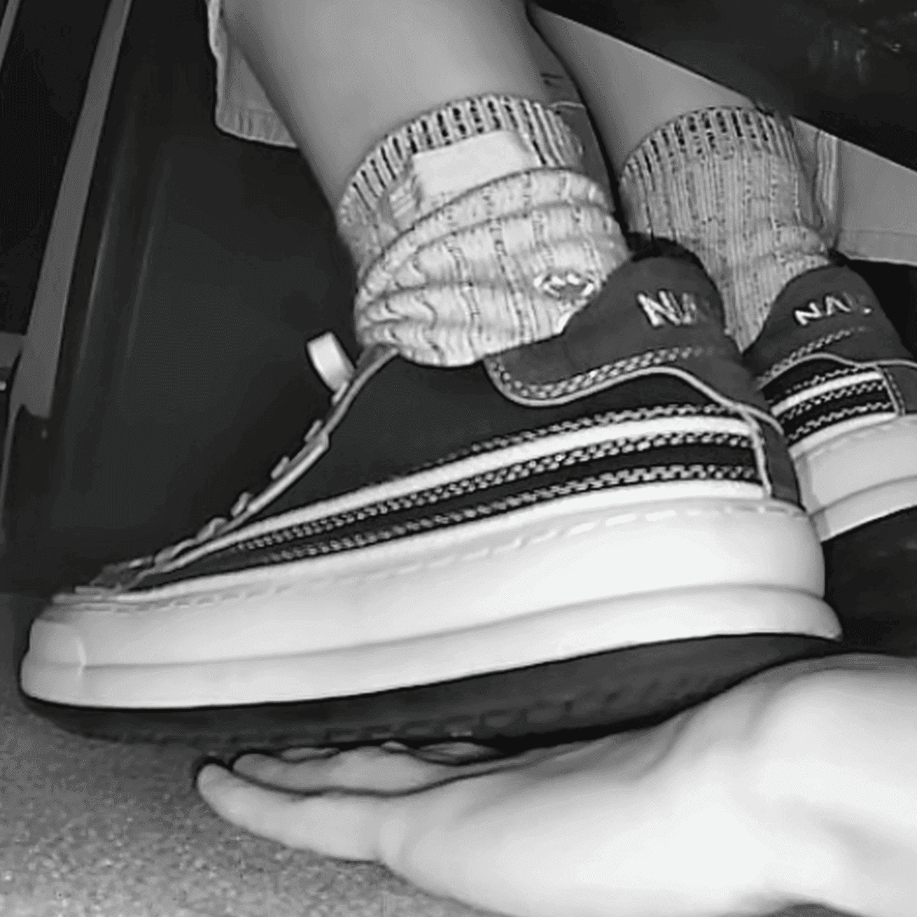 Woman in canvas shoes unaware hand trample in cinema