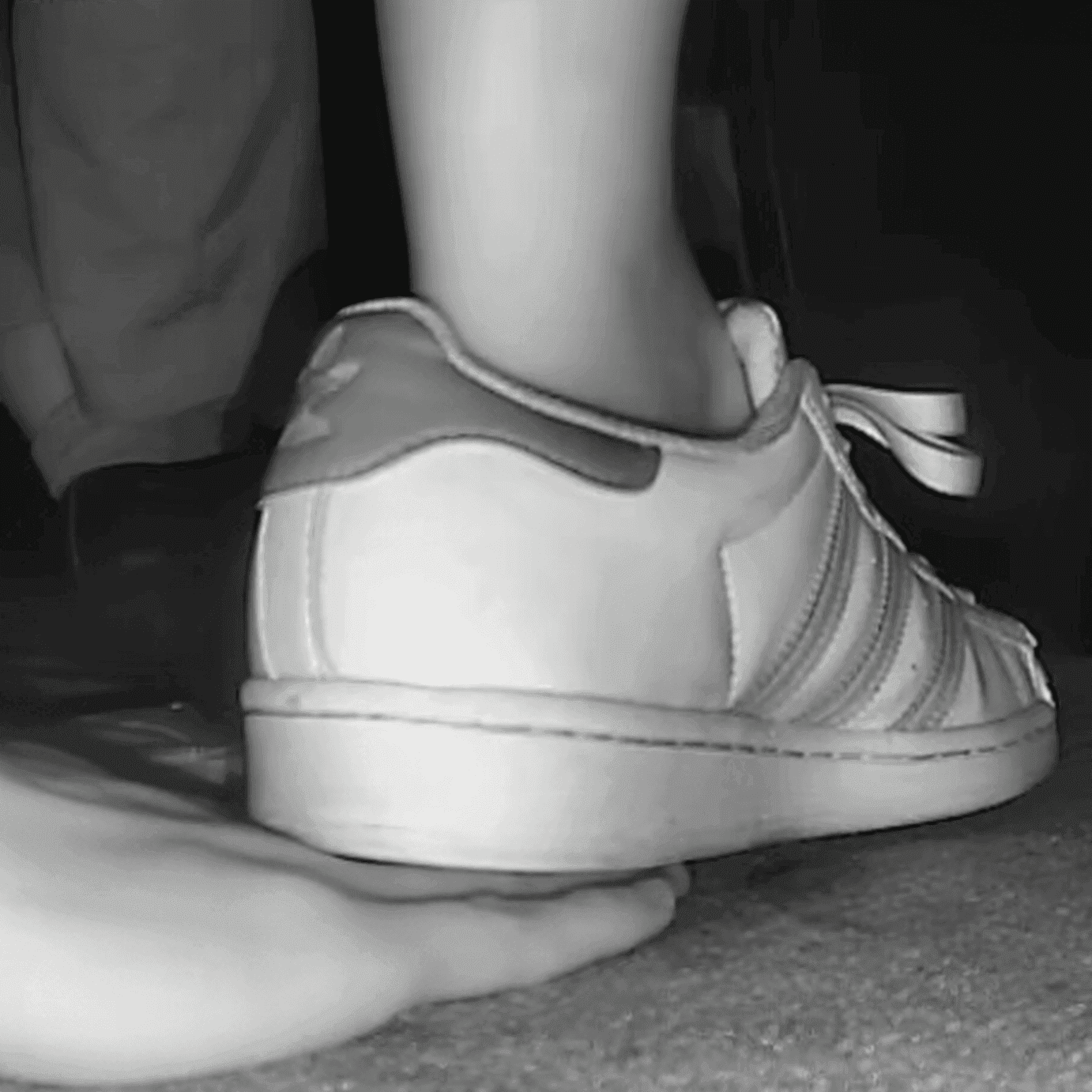Woman adidas superstar + fila sneaker unaware hand trample in cinema