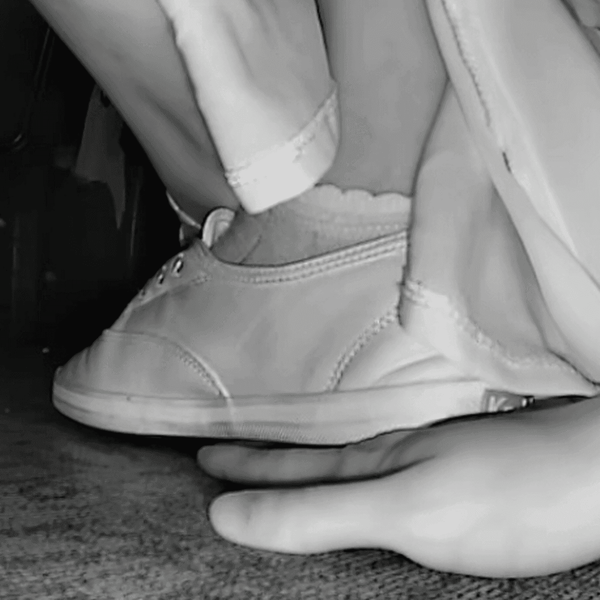 Woman wearing a dress unaware hand trample with Keds canvas shoes at the movie theater thumb 2