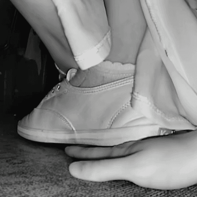Woman wearing a dress unaware hand trample with Keds canvas shoes at the movie theater 2