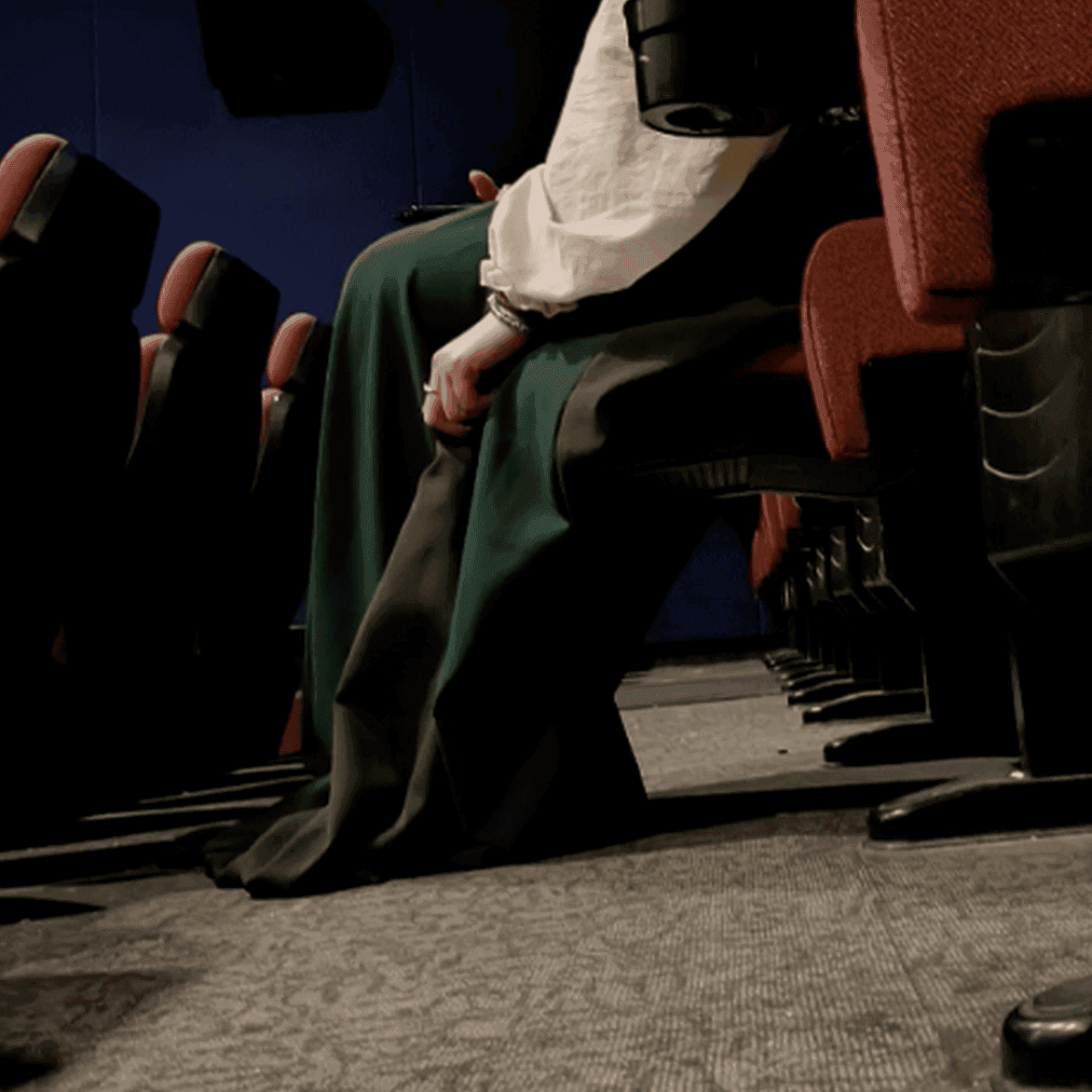 Woman wearing a dress unaware hand trample with Keds canvas shoes at the movie theater thumb 3