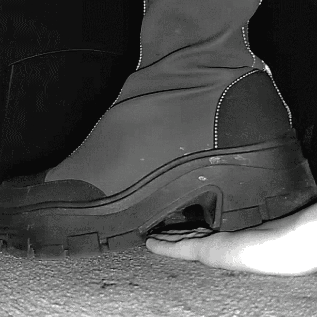 Woman with chunky-heeled knee-high boots unaware hand trample in cinema thumb 2