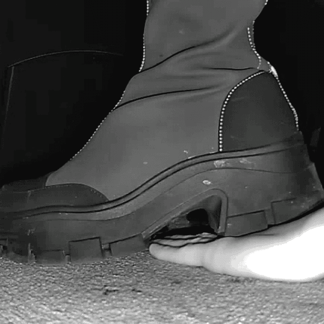 Woman with chunky-heeled knee-high boots unaware hand trample in cinema 2