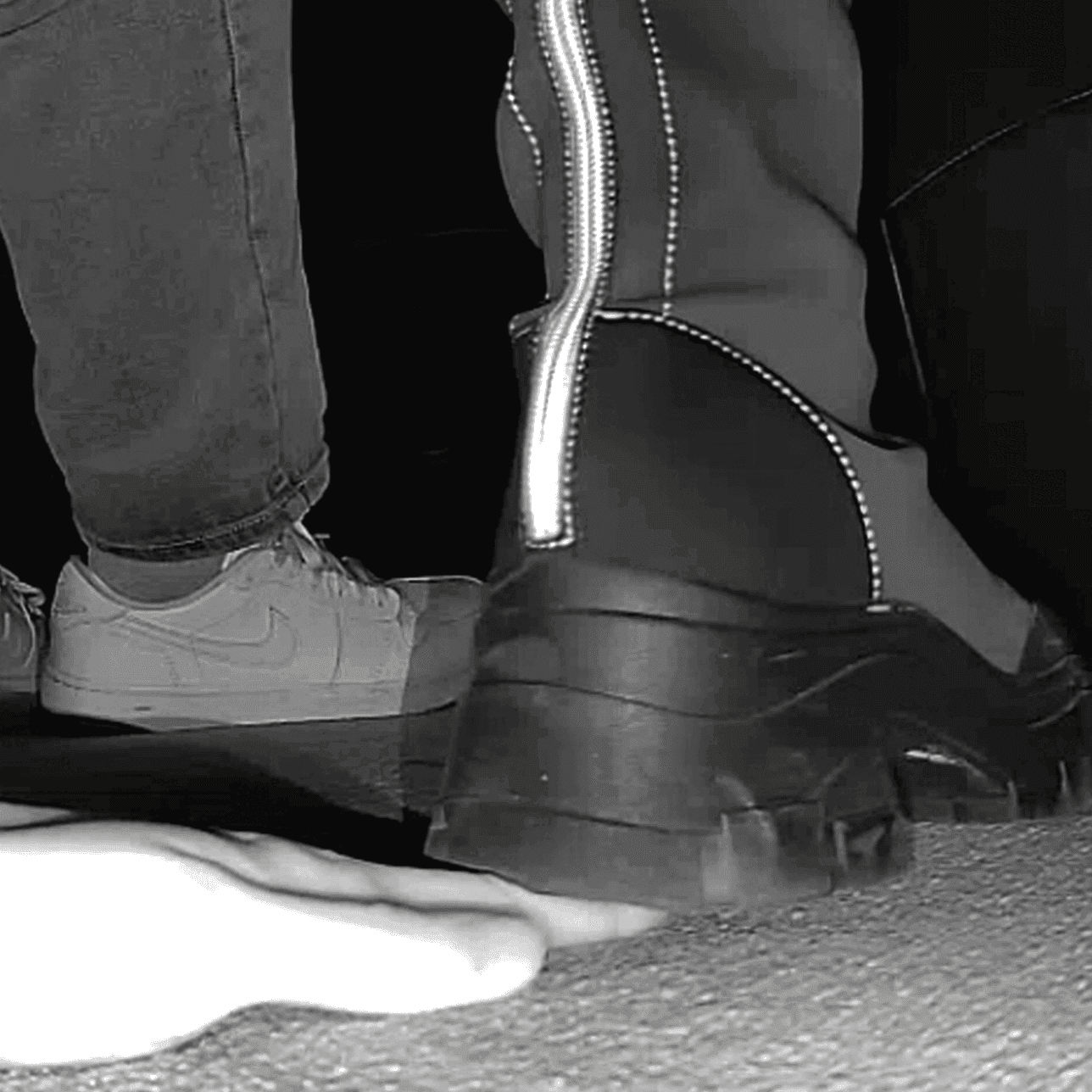 Woman with chunky-heeled knee-high boots unaware hand trample in cinema thumb 3