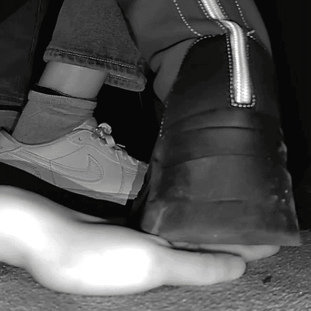 Woman with chunky-heeled knee-high boots unaware hand trample in cinema 4