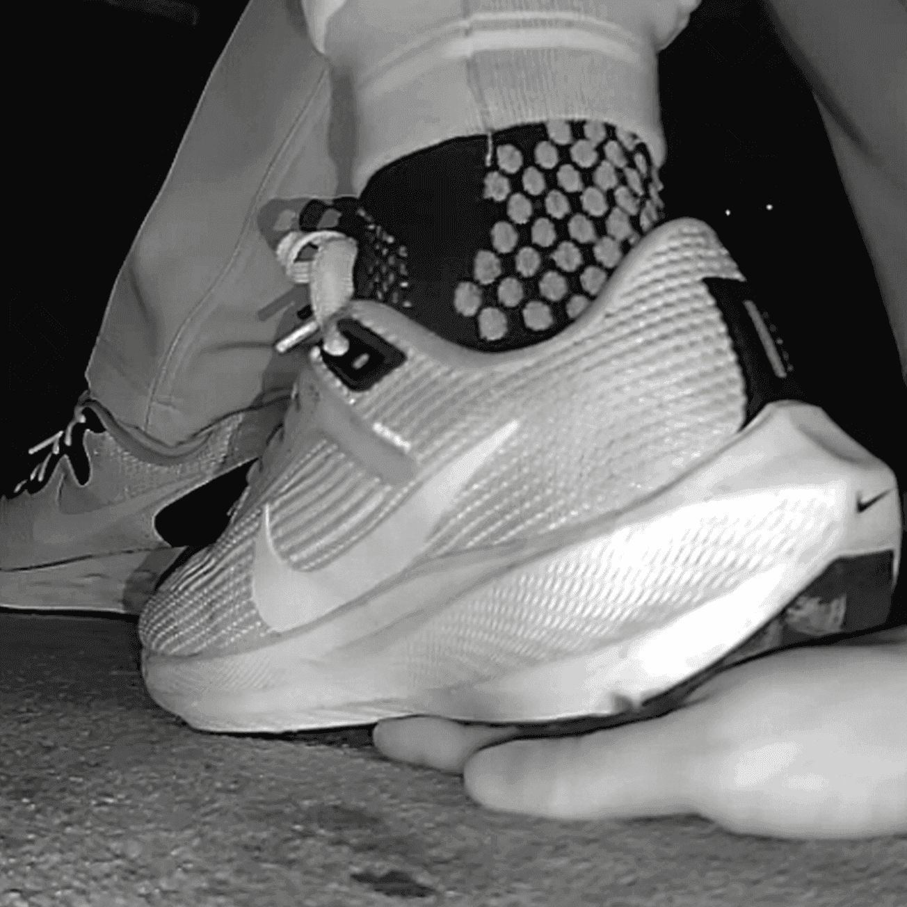 Young woman unaware hand trample with Nike running shoes in cinema