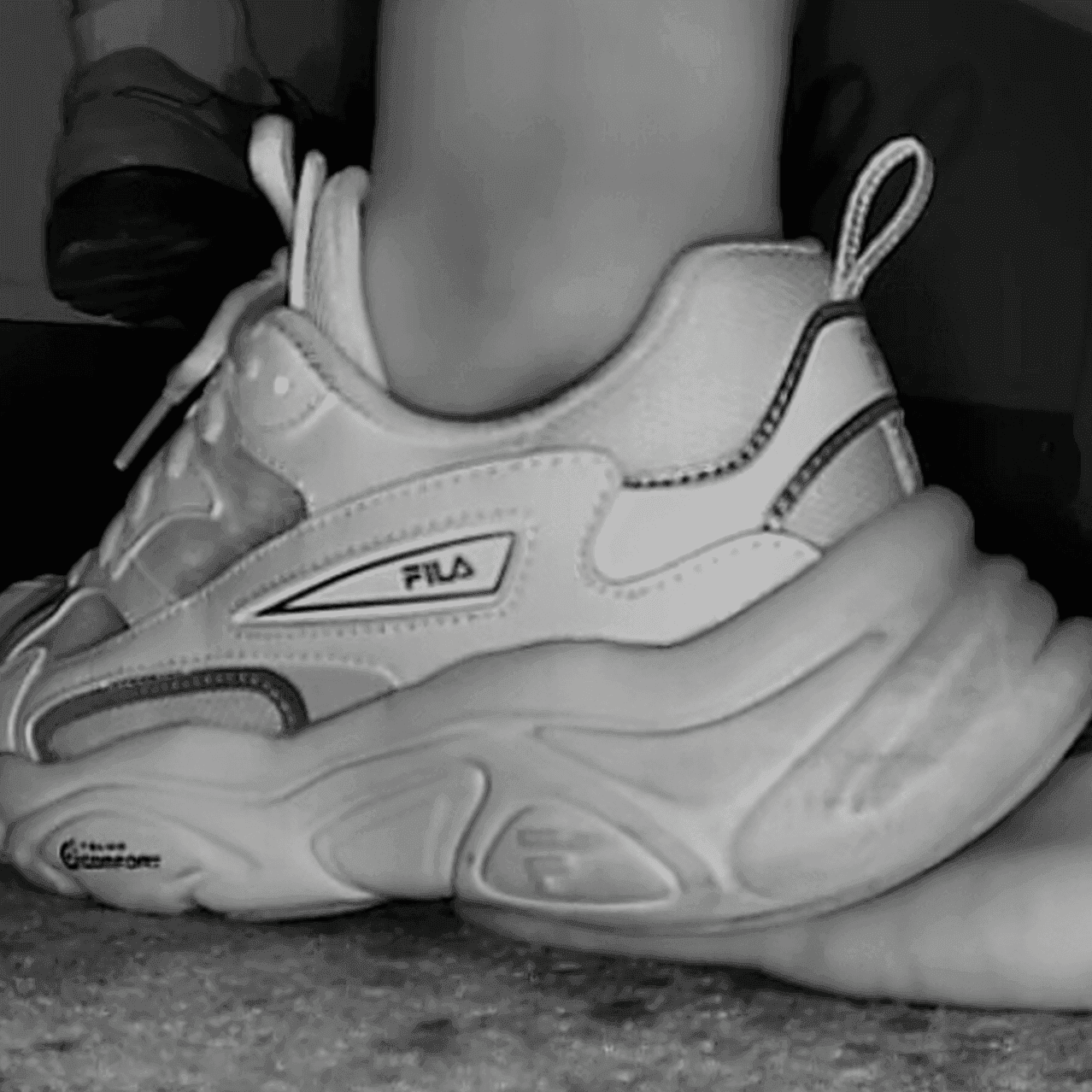 Woman wearing fila sneaker unaware hand trample in cinema