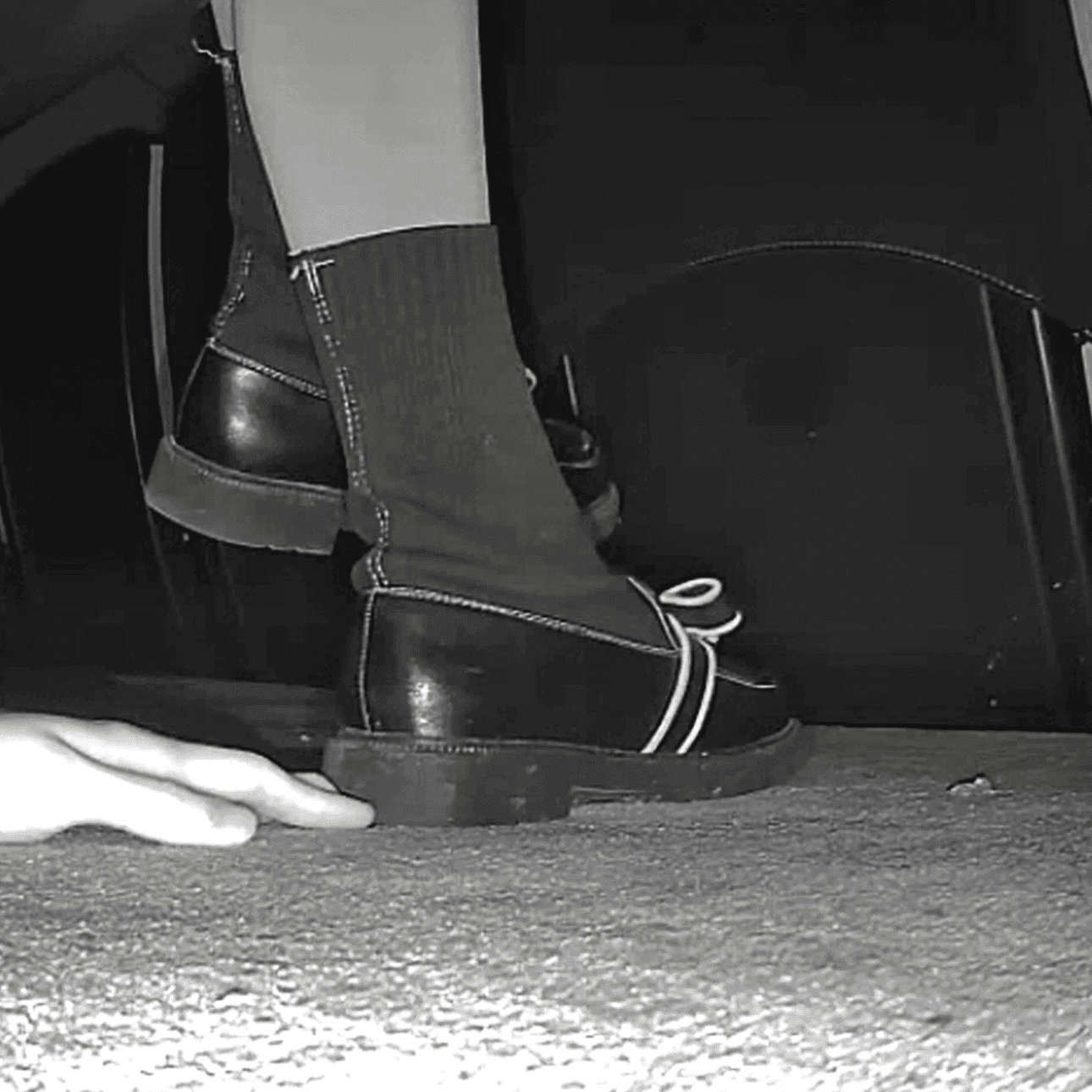 Beautiful woman unaware hand trample with black leather shoe heels thumb 3