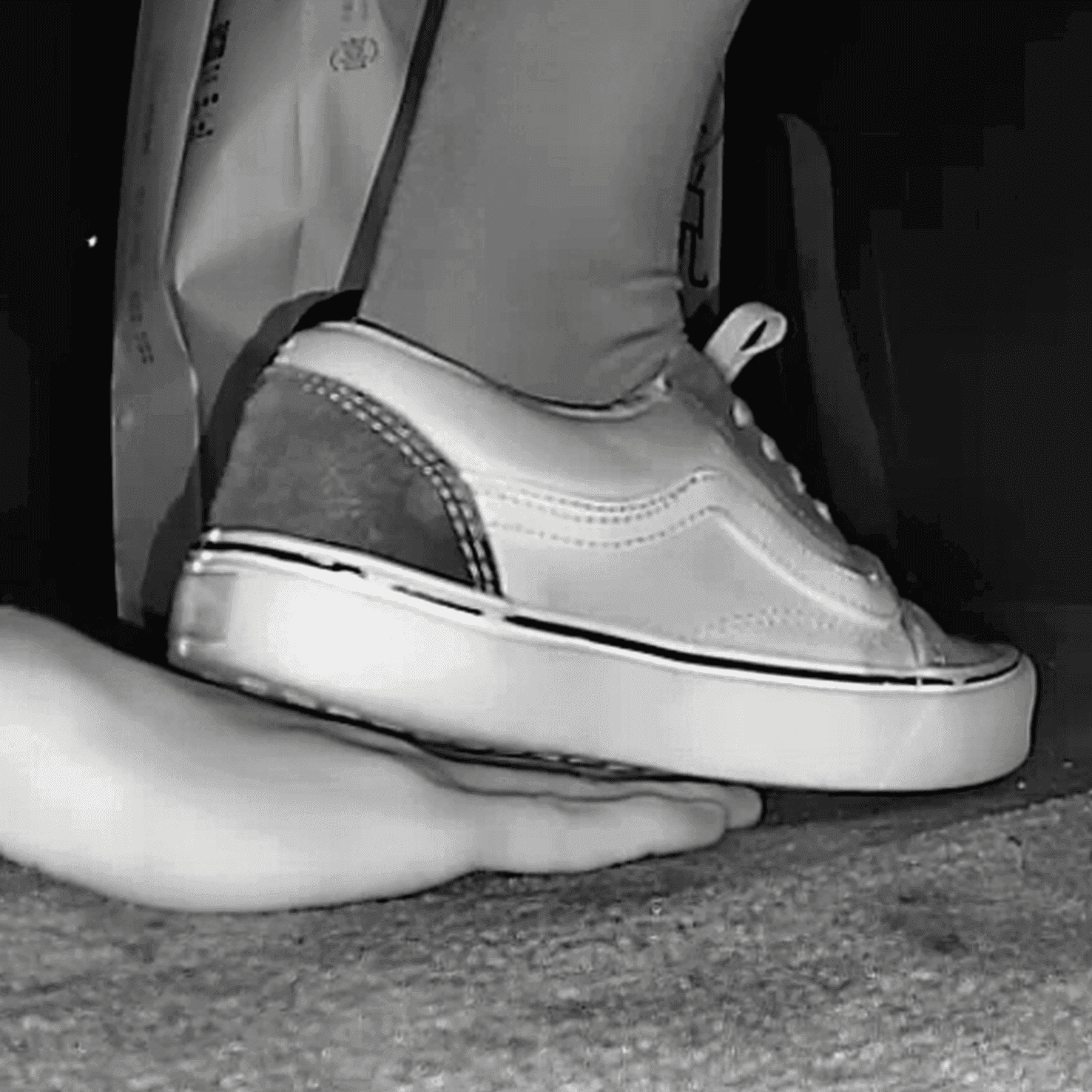 Woman black Converse shoe + Vans unaware hand trample in cinema